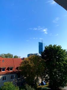 a view of a city skyline with a tall building at Apartament Oliwa in Gdańsk