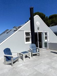 two chairs sitting on a patio in front of a building at Myrtle Loft in Cape Town +11 photos