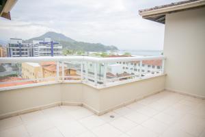 a balcony with a view of the ocean at Paramar Praia Grande in Ubatuba