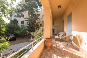an apartment balcony with a view of a yard at The Little Palace of Paleo Psychiko in Athens