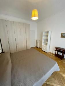 a room with a large bed and a table at La Casa di Titilla in Turin