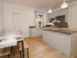 a kitchen and dining room with a table and chairs at Park Beck in Windermere