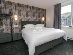 a bedroom with a large bed with towels on it at Park Beck in Windermere