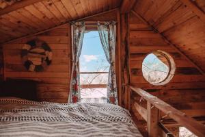 a bedroom with a bed in a wooden cabin at Apple Tree Cabin (Friendship Land) 