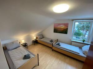 a room with two beds and a window at Apartments with Garden in Bad Vilbel