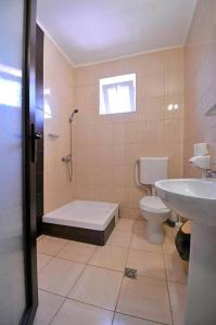 a bathroom with a shower and a toilet and a sink at Calla Inn Hotel in Constanţa