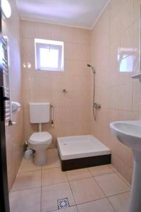 a bathroom with a toilet and a sink at Calla Inn Hotel in Constanţa
