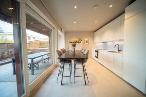 a kitchen with a table and chairs and a dining room at Tromsø Town House in Tromsø