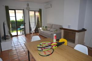 a table with a tennis racket on it in a living room at Bahia Vista - Chalet adosado con vista al mar in Finestrat