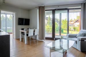 a living room with a table and a couch at Harenda Residence in Zakopane