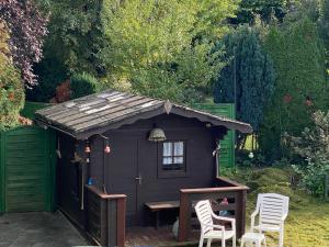 a small shed with a table and chairs in a garden at Apartments with Garden in Bad Vilbel