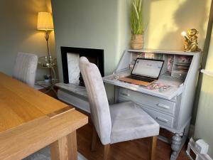 a desk with a laptop computer on top of it at Stylish & Homely 3 BR House in Sale