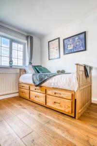 a bedroom with a wooden bed in a room at Pangbourne House in Higham on the Hill