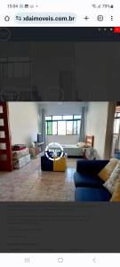 a living room with a couch and a table at Quarto e sala Boqueirão quadra da praia in Santos