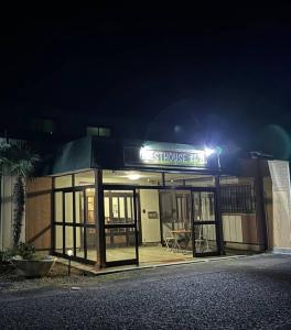 a building with a sign on it at night at Guest House Koriyama in Koriyama