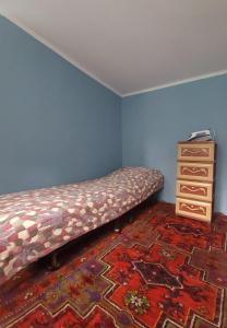 - un lit dans une pièce à côté d'une commode dans l'établissement Gabala Garden hostel, à Qabala