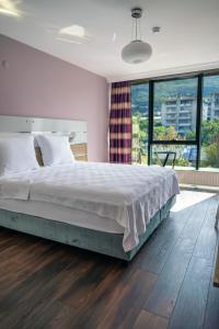 a bedroom with a large bed and a large window at TOK EPİK HOTEL in Bursa