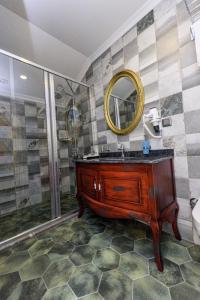 a bathroom with a sink and a shower with a mirror at TOK EPİK HOTEL in Bursa