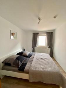 a bedroom with a large bed in front of a window at Ferienwohnung Riese Nordhessen in Felsberg