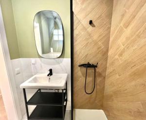 a bathroom with a sink and a mirror at Casa Diogo in Faro