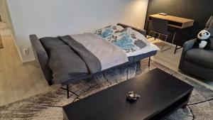 a living room with a couch and a coffee table at Stylish apartment in town centre in Sotkamo