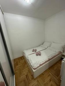 - une chambre avec un lit avec deux chaussures dans l'établissement Nelly, à Sarajevo