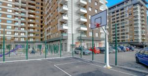 a basketball hoop in a parking lot next to a building at Apartments Sarajevo Nova Otoka in Sarajevo
