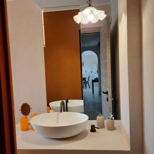 a bathroom with a large white sink in front of a mirror at Villa Anna Buonvino in Giovinazzo