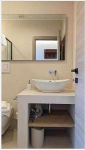 a bathroom with a white sink and a mirror at Villa Anna Buonvino in Giovinazzo +20 photos