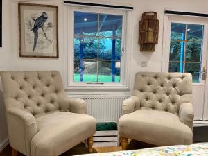 sala de estar con 2 sillas y ventana en Oak View Lodge: Cosy, Countryside Retreat, en Maybole