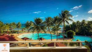 a view of the pool from the balcony of a resort at Ti Kaz Funky Host -T3 vue mer prémium 3 étoiles - Village vacances Sainte Anne Guadeloupe in Sainte-Anne