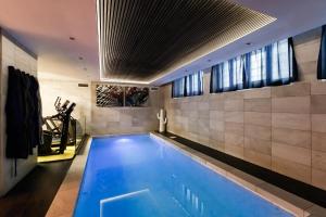 a swimming pool in the middle of a room at N18 luxury boutique apartment with a private pool & spa in Milan