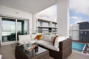 a living room with a couch and a table at Sea view - dream Nazaré in Nazaré