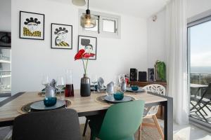 a dining room with a wooden table and chairs at Sea view - dream Nazaré in Nazaré