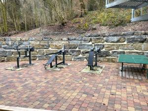 a stone wall with two benches and a table at "Alte Fabrik" Ferien-und Seminarhaus 