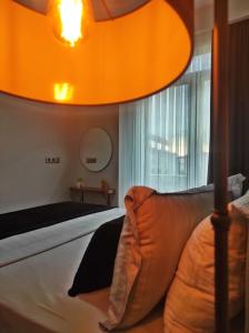 a bedroom with a bed and a large orange lamp at SABIHA GOKCEN HOTEL İSTANBUL HOUSES in Istanbul