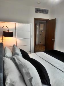 a bedroom with a bed with white sheets and pillows at SABIHA GOKCEN HOTEL İSTANBUL HOUSES in Istanbul