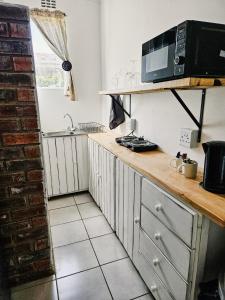 a kitchen with a counter top with a microwave at Apartment on 4th Avenue in East London