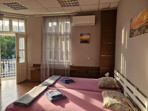 a bedroom with a large bed and a window at Lambo's Corner Varna in Varna City