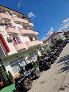 a row of motorcycles parked in front of a building at Hotel Montenegro in Struga