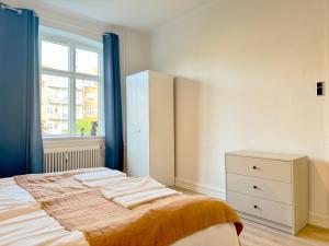 - une chambre avec un lit, une commode et une fenêtre dans l'établissement Perfect Apartment For Travelers On A Budget - But Still Wants Quality, à Randers