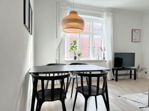 - une salle à manger avec une table et quatre chaises dans l'établissement Perfect Apartment For Travelers On A Budget - But Still Wants Quality, à Randers