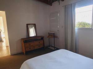 a bedroom with a bed and a mirror and a dresser at Aime in Esquel