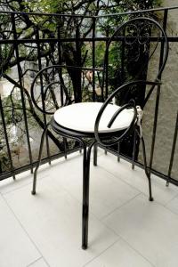 a black and white chair sitting on a balcony at Flowers Premium Apartments & Rooms in Zagreb