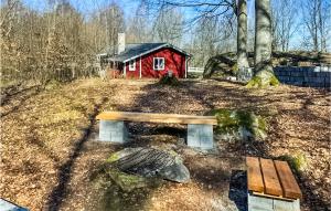 a bench sitting in front of a red house at Nice Home In Tyringe With House A Panoramic View in Tyringe