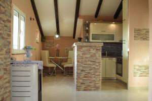 a kitchen with a counter and a table in a room at Apartments Marica in Zadar
