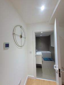 a white bathroom with a tub and a sink at Amazing Canterbury 1 BR Flat in London CB54 in Croydon