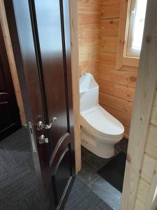 a bathroom with a toilet sitting next to a door at Biwako Hills Resort - Vacation STAY 48007v in Takashima