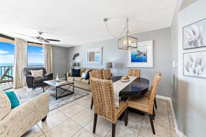 a dining room and living room with a table and chairs at Phoenix East 904 in Orange Beach