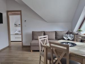 a living room with a couch and a table and chairs at Near the airport- Apartments in Kraków